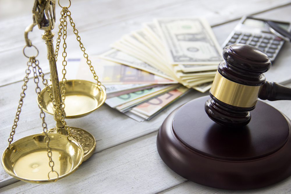Scales, money, gavel on table