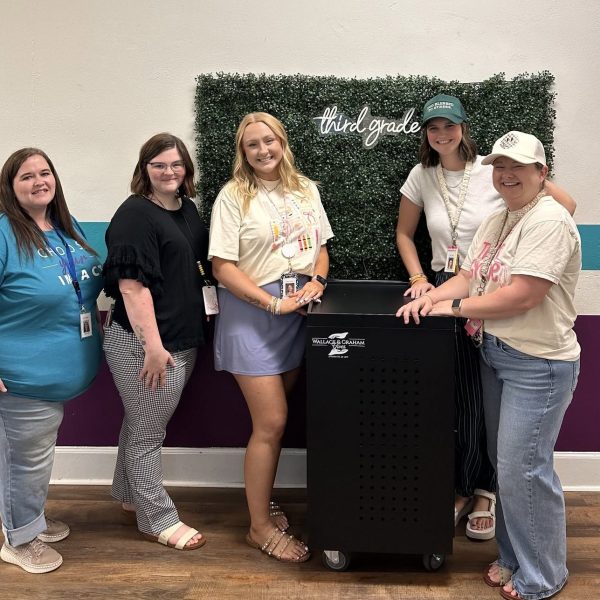 Women standing in front of technology cart